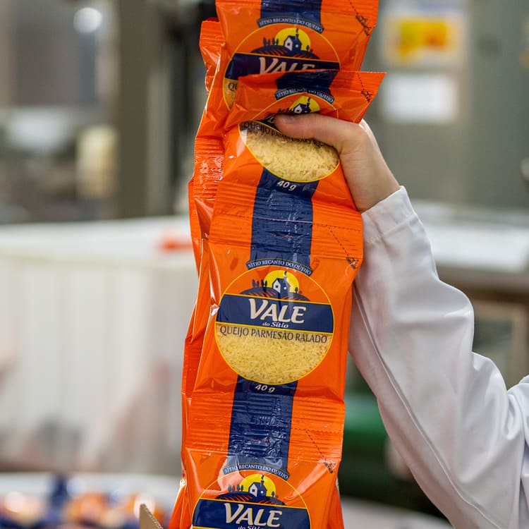 Embalagem de queijo parmesão ralado na produção